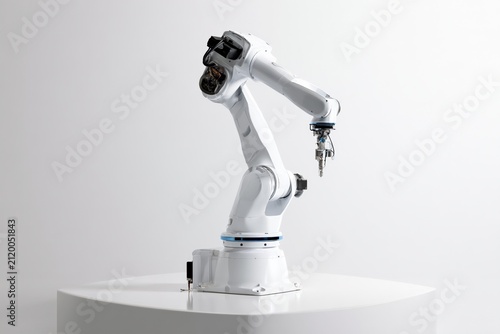 advanced industrial robotic arm with precision end effector on white pedestal, minimalist automation system for smart manufacturing, artificial intelligence and next generation robotics concept
