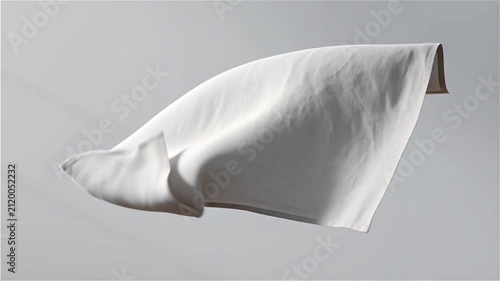 Soft white fabric gently flowing and waving in slow motion against pure light gray background