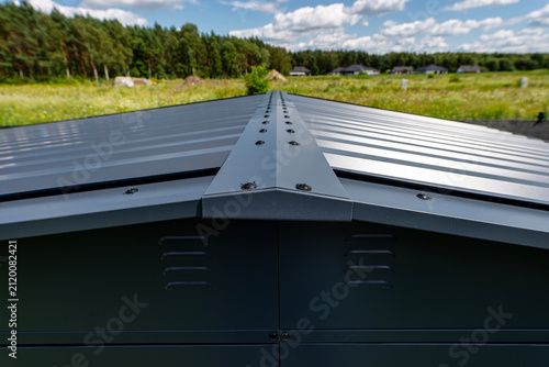 Modern metal roof ridge cap on a farmhouse