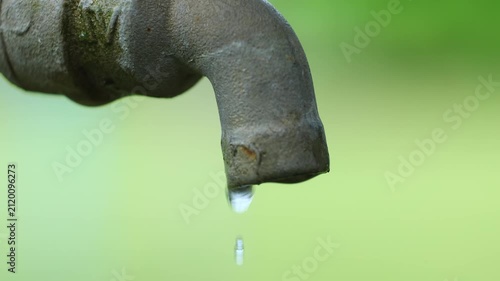Water Droplet Dripping from an Old Faucet