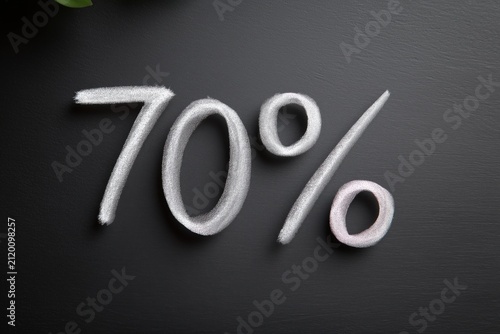 Metallic seventy percent discount text on dark background, retail promotion, premium branding, luxury sale, ecommerce campaign.