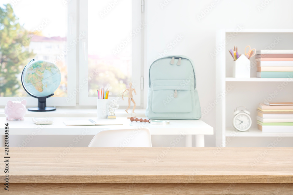 Fototapeta premium Empty wooden table with copy space on blurred modern student workplace background