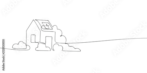 Фотография House with rooftop solar panels surrounded by bushes