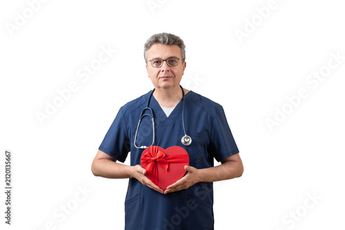 Фотография A middle-aged male doctor holds a symbolic human heart.