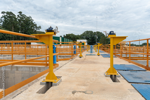 Canvastavla Central walkway with sluice gates and water treatment infrastructure under cloud