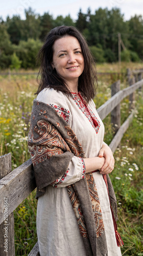Portrait of a young woman, beautiful village girl in a linen dress