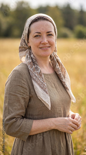 Portrait of a young woman, beautiful village girl in a linen dress