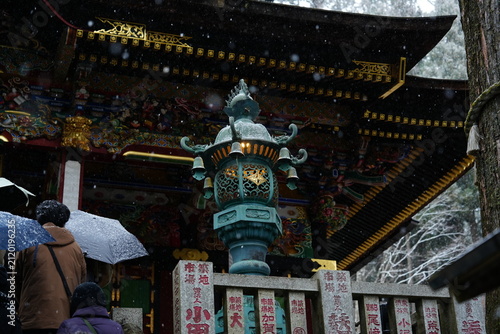 Принти на полотні Traditional bronze lantern lit up at Japanese Mitsumine shrine during winter sno