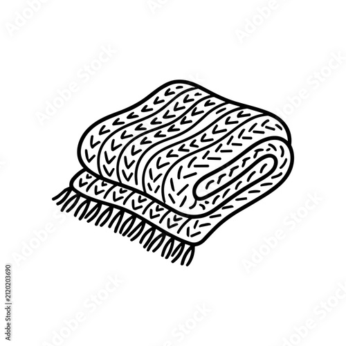 Rolled up knitted blanket with fringe.