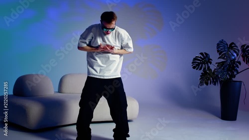 Urban dance pose with arms extended in colorful studio