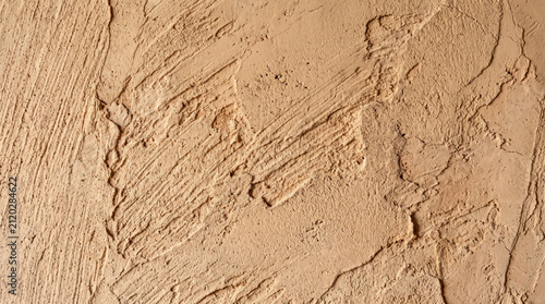 Chalky lime plaster with visible trowel marks, muted terracotta tone