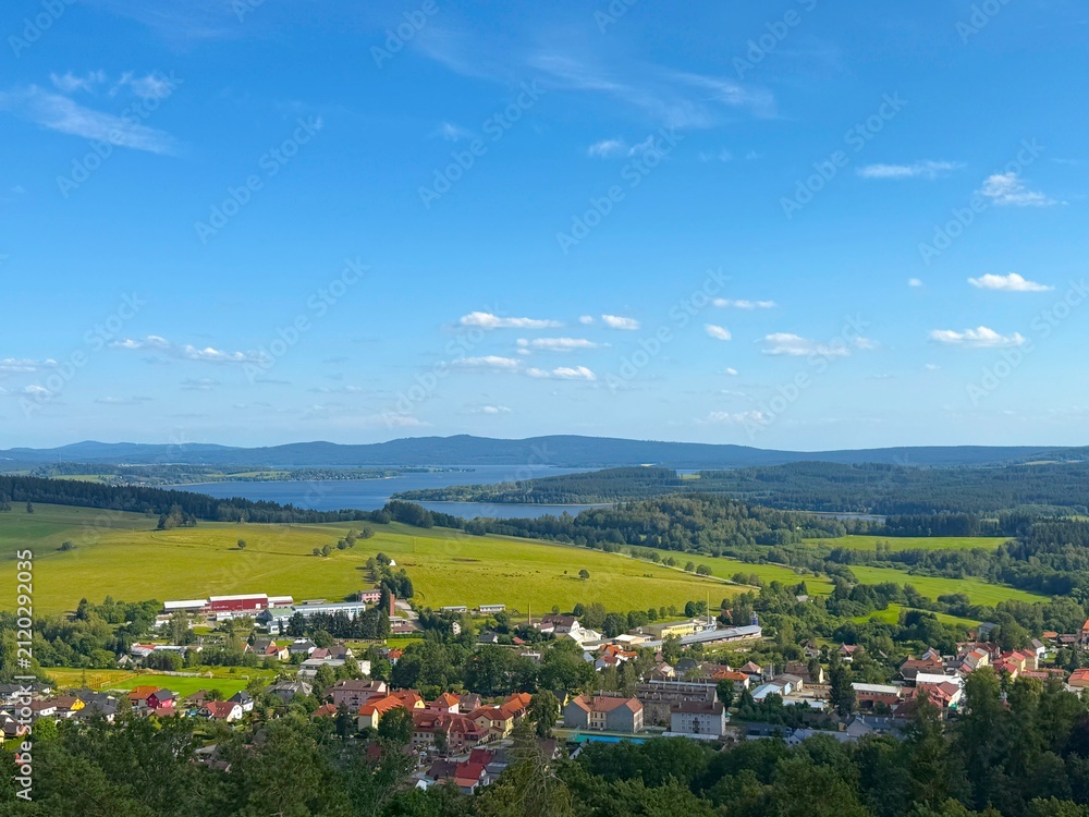 Fototapeta premium Green alpine meadows in Lipno, Czech Republic, surrounded by beautiful natural landscape.