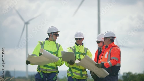 Engineers working on site in wind turbine farm, Wind turbines generate clean energy source, Eco technology for electric, industry environment.
