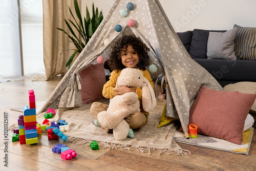Canvas Print Joyful playtime of a cheerful boy in his cozy modern apartment