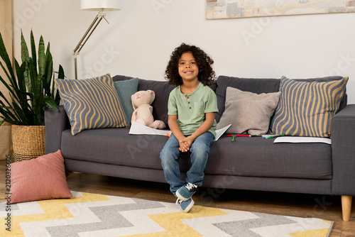 Принти на полотні Happy boy enjoying playtime in a cozy modern apartment filled with joy