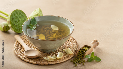 Natural herbal beverage still life featuring mung beans, lotus seeds and rustic table setting with elegant copy space
