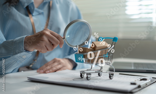 Consumer shopping concept with magnifying glass examining shopping cart, discount symbols, price comparison, online shopping, smart buying, retail promotion, ecommerce savings, and purchase decision.