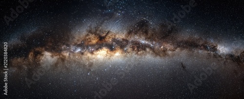 A sweeping panoramic view of the Milky Way galaxy's core, rich with stars and cosmic dust