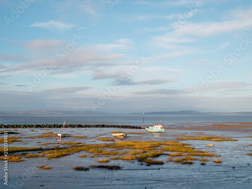 Small boats on tidal mudflat at low tide in Morecambe