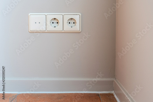 3-fold European wall socket assembly with one cover and two Schuko power outlets