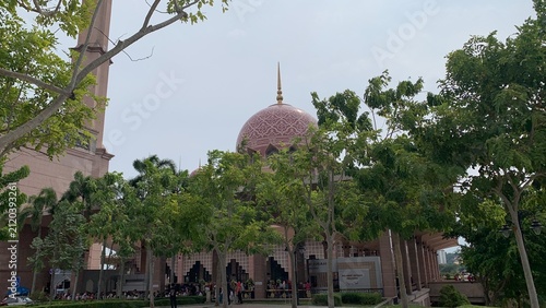 Принти на полотні domed mosque partially framed by lush trees and landscaped grounds in Putrajaya