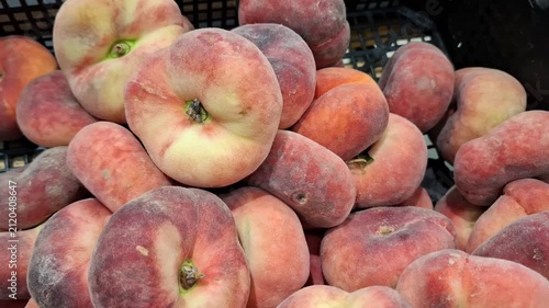 Ripe peaches with soft fuzzy skin arranged in a close up, fresh fruit, healthy eating, summer harvest, natural food.