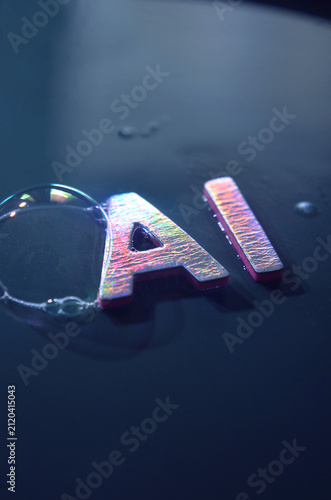 Фотография Bubble touching the word AI in metallic letters
