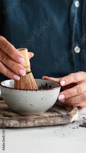 Woman Making Blue Matcha Tea Whisking It In A Chawan Close-Up