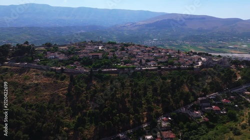 aerial drone fly above historic hilltop settlement and ancient fortifications of Berat Castle Albania travel destination in Balkans Europe 