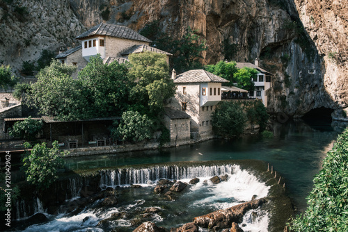 Bild auf Leinwand Blagaj Tekija Sufi monastery nestled under a massive limestone cliff beside the