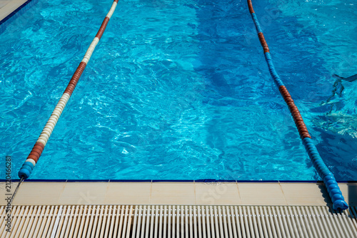 Clear blue swimming pool lane with divider lines