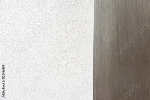 White textured wall with vertical wooden panel detail