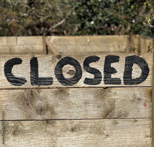 Close up of weathered wooden crate with bold black painted letters, rough grain