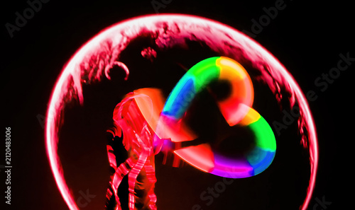 Colorful light shapes appear in dark background as person dances with glowing stick at night
