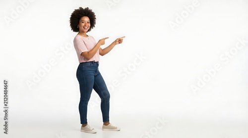Ultra-realistic full body portrait of a young Black woman standing sideways while pointing enthusiastically toward empty copy space with both hands
