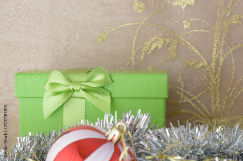 Christmas background with a green gift box and bow