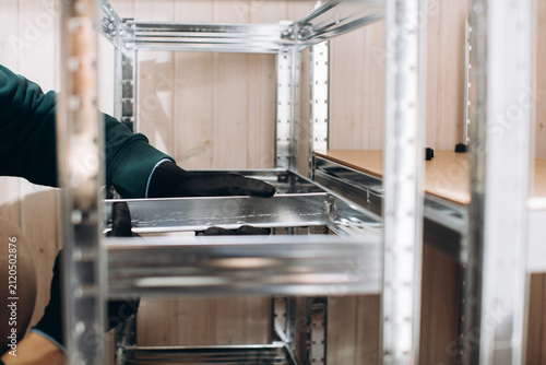 Obraz na plátně Assembling metal shelving unit for storage organization