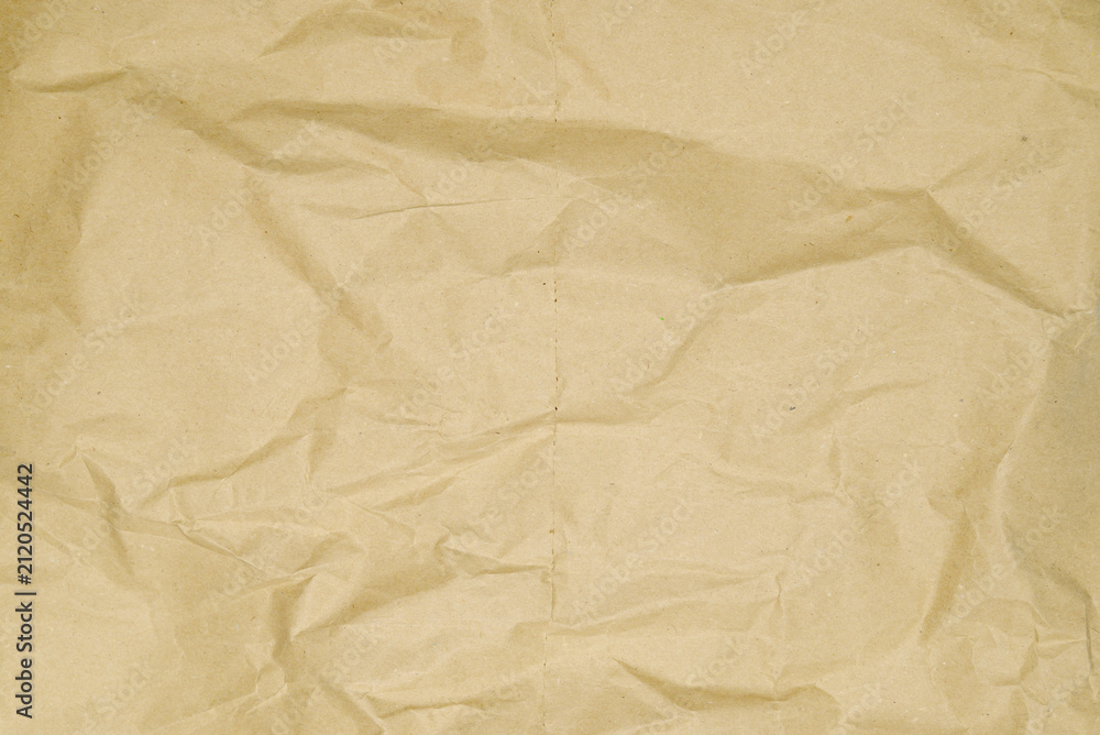 Fototapeta premium crumpled brown kraft paper with expressive texture wrinkles and folds across surface