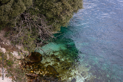 Crystal Clear Turquoise Water on the Rocky Shore of Lake Garda, Italy