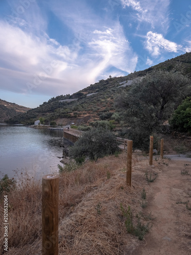 Trail waymarkers guiding hikers along the Sao Mamede de Ribatua route in Alijo, Portugal. Scenic boardwalks and gravel paths near the Tua River in the Douro Valley.