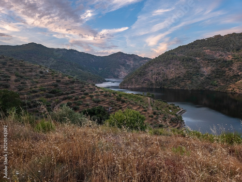 Trail waymarkers guiding hikers along the Sao Mamede de Ribatua route in Alijo, Portugal. Scenic boardwalks and gravel paths near the Tua River in the Douro Valley.