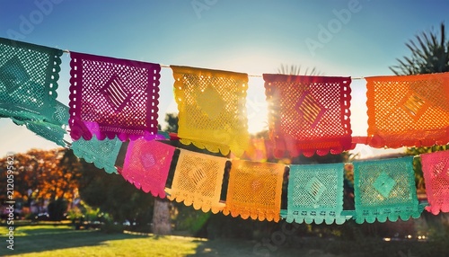 mexican fiesta vibrant papel picado banners in sunlit outdoor