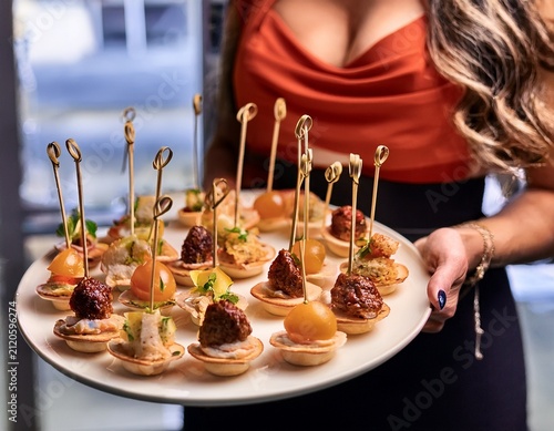 elegant finger food presentation at a sophisticated event with guest holding