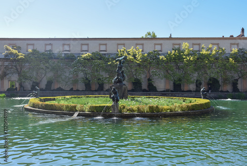 The Hercules Fountain in Waldstein Garden, featuring Hercules battling a dragon, surrounded by water nymphs on an island in the garden pond