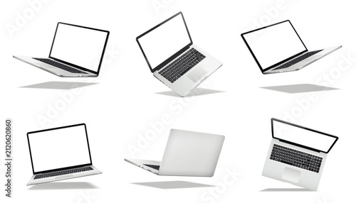 Falling or levitate laptop computers with blank screen isolated on white background with shadow