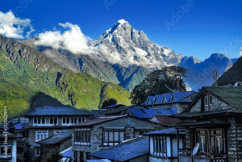 Obraz na płótnie view of mountain village in Everest region with majestic snowy peak Ama Dablam under clear blue sky