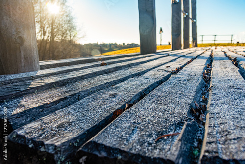 Frosty wooden boardwalk at sunrise