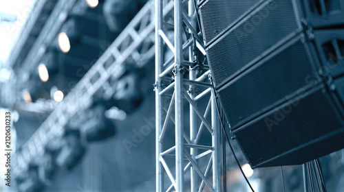Concert production. Professional line array speakers mounted on an aluminum truss system for live concert sound reinforcement and large event audio coverage.