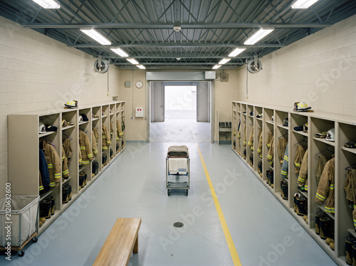 Empty fire station bunker gear locker room with aligned turnout coats isometric overhead floor plan
