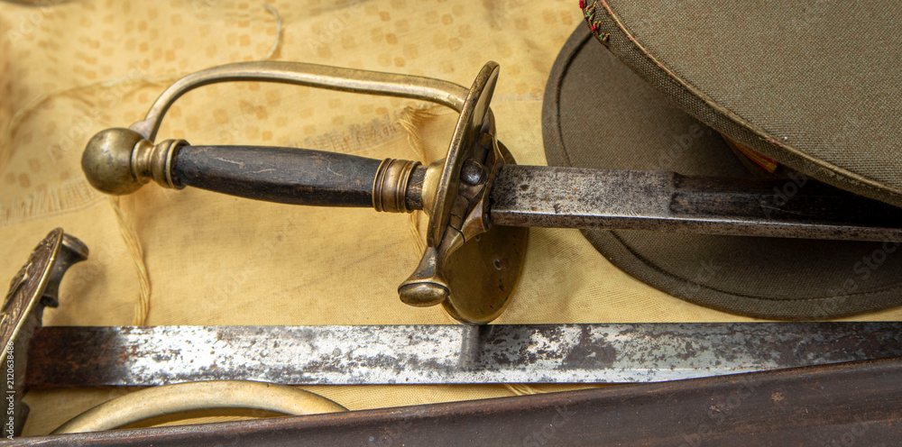 Obraz premium Antique military rapier and uniform cap showcasing history of armed forces